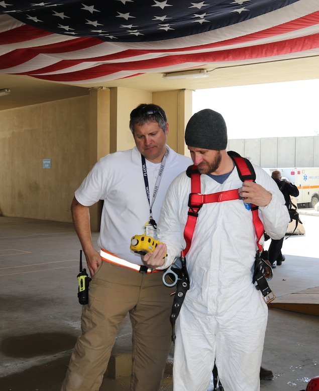 David Lynne, Area Support Group-Afghanistan and George Parker, Flour Fire Department discuss readings from a wireless portable multi-gas monitor. The Bagram Fire Department provided ongoing, continuous monitoring for combustion risk, oxygen concentration, carbon monoxide, and other hazardous gases, as well as emergency first response and extraction capability.
