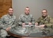 Col. Sean Tyler (center), 633rd Air Base Wing commander, signs the Air Force Assistance Fund Campaign contribution forms with Chief Master Sgt. Shane Wagner (right), 633rd ABW command chief and Master Sgt. Daniel Linares.