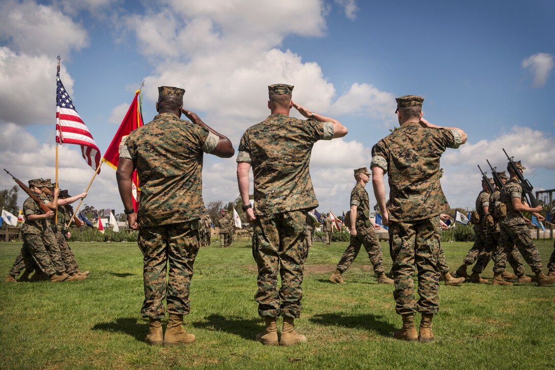 Leaders with Headquarters and Headquarters Squadron (H&HS), salute the colors during a relief and appointment ceremony on Marine Corps Air Station Miramar, Calif., Mar. 22. The ceremony formally recognized Sgt. Maj. Broadus for his honorable service and welcomed Sgt. Maj. Lewis as the new squadron sergeant major. (U.S. Marine Corps photo by Cpl. Becky Cleveland)