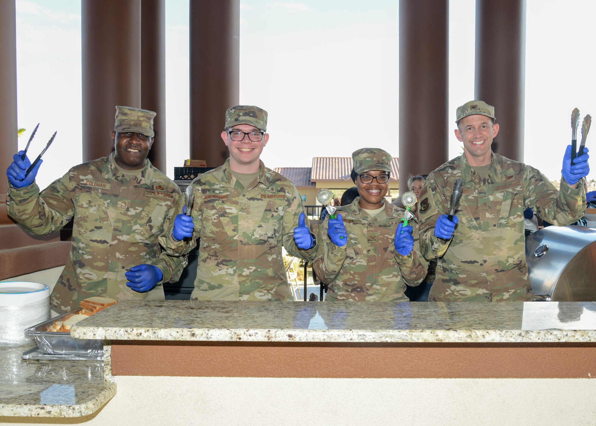 Chief Master Sgt. James Coleman, 412th Test Wing acting command chief, Airman 1st Class Cameron Hawthorne, 412th Aerospace Medicine Squadron, Staff Sgt. Akina Jones, 412th AMDS, and Brig. Gen. E. John Teichert, 412th TW commander, pose for a photo during a Strong Family Program event at the Mojave Sky Community Center at Edwards Air Force Base, California, March 18. (U.S. Air Force photo by Giancarlo Casem)
