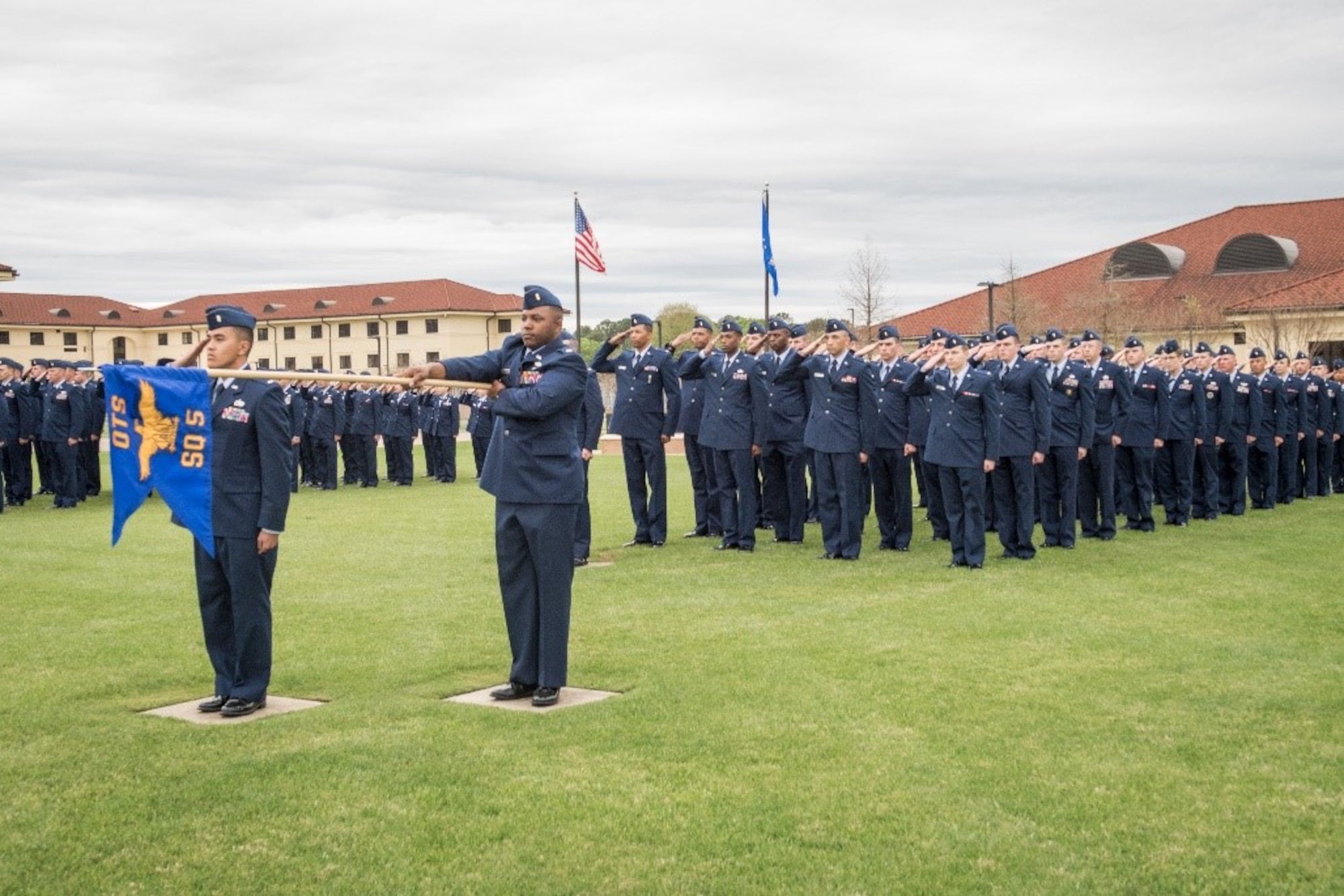 Air Force Officer Training School officer trainees salute during the ceremonial playing of ‘Ruffles and Flourishes,’ March 15, 2019, Maxwell Air Force Base, Alabama. This graduating class of officers is the largest ever and one of the first under the new consolidated OTS training program. (U.S. Air Force photo by Airman First Class Matthew Markivee)