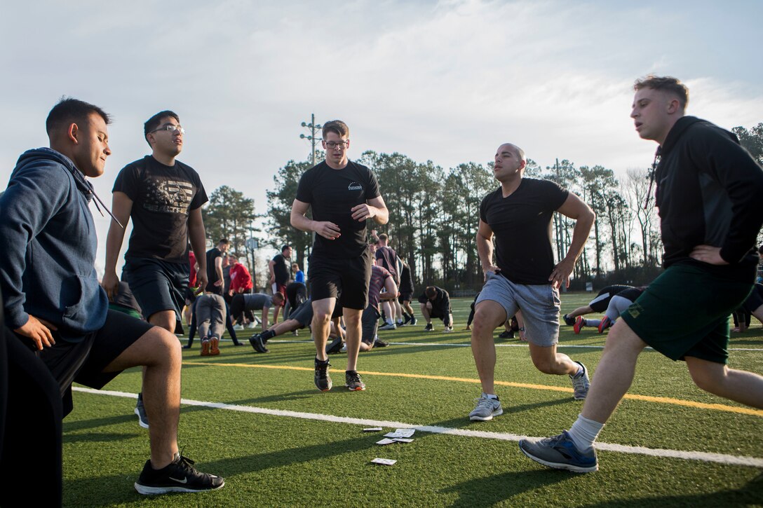 U.S. Marines and Sailors with 24th Marine Expeditionary Unit execute physical training at Camp Lejeune, N.C., Feb. 28, 2019. The training was held to promote unit cohesion and readiness. (U.S. Marine Corps photo by Lance Cpl. Larisa Chavez)