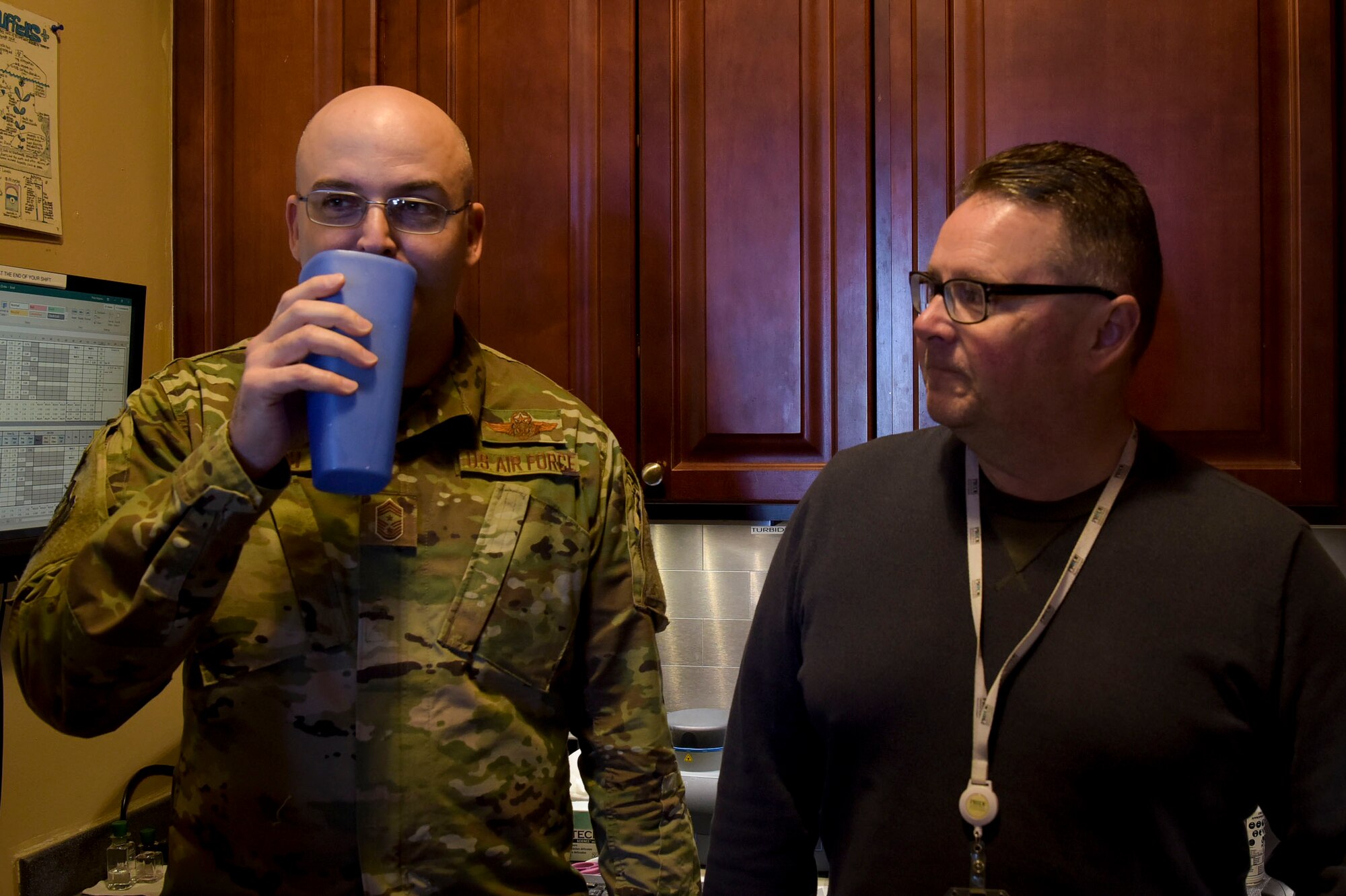 U.S. Air Force Chief Master Sgt. James Fitch, 87th Air Base Wing command chief, tastes freshly produced water during a Water Production Plant tour, March 26, 2019 at Joint Base McGuire-Dix-Lakehurst, New Jersey. Senior leadership received a tour from Robert Lauer (right), who is the Pride Industries Water Treatment Plant assistant manager. (U.S. Air Force photo by Airman 1st Class Briana Cespedes)