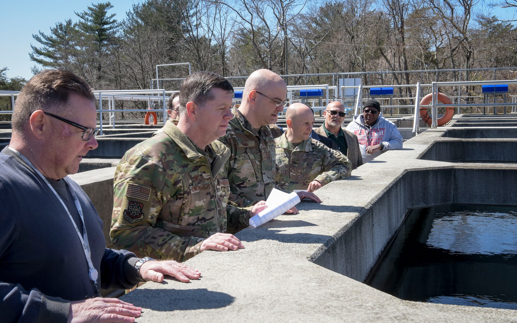 (Left) Robert Lauer, Pride Industries Water Treatment Plant assistant manager, observes the settling flocculation basins during a Water Production Plant tour, March 26, 2019 at Joint Base McGuire-Dix-Lakehurst, New Jersey. Lauer conducted a tour for U.S. Air Force Col. Neil R. Richardson, Joint Base MDL and 87th Air Base Wing commander, U.S. Air Force Chief Master Sgt. James Fitch, 87th ABW command chief, and U.S. Army Col. Daniel Grassetti, U.S Army Support Activity-Fort Dix deputy commander. (U.S. Air Force photo by Airman 1st Class Briana Cespedes)