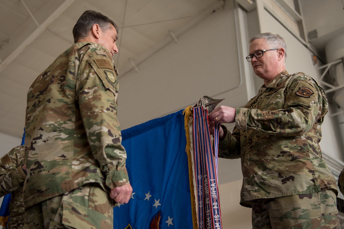 Col. David Mounkes (right), commander of the 123rd Airlift Wing, pins a streamer to the unit colors during a ceremony at the Kentucky Air National Guard Base in Louisville, Ky., March 10, 2019. The streamer signifies the unit’s selection for its 18th Air Force Outstanding Unit Award, continuing its legacy as one of the most decorated organizations in U.S. Air Force History. (U.S. Air National Guard photo by Staff Sgt. Joshua Horton)