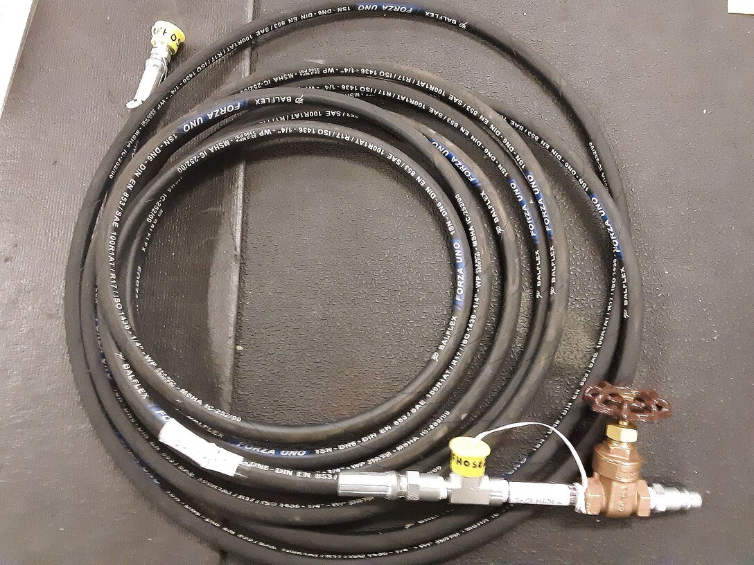 This new vent system pressurization tool was created by members of the 552nd Aircraft Fuel Systems unit, the Oklahoma City Air Logistics Complex, and civilian engineers based out of Tinker Air Force Base. This tool, which is over 26 ft. long and typically has a gauge on it, was created in less than 12 hours after retrieving parts from local supply stores in Oklahoma City. (U.S. Air Force photo/ Master Sgt. Richard E. Newman)