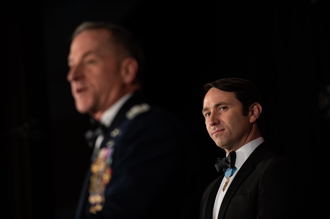 Soft focus on general in foreground introducing Medal of Honor recipient in background