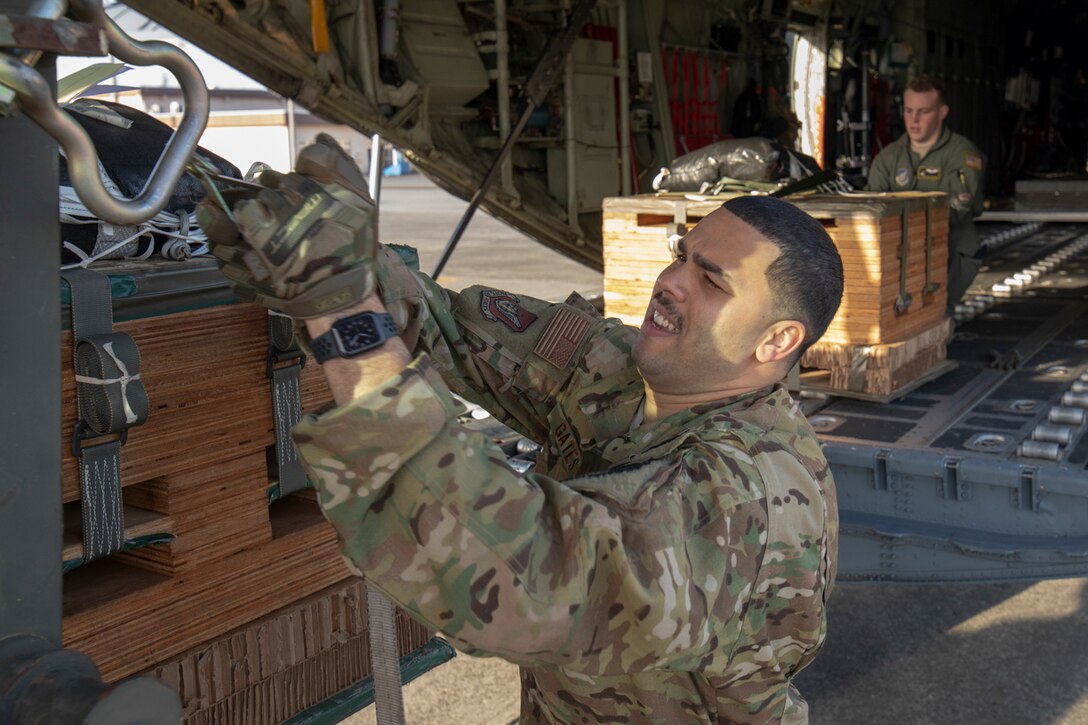 (Front to back) Tech. Sgt. Brian Gates and Airman 1st Class Matthew Pfeffer, 36th Airlift Squadron loadmasters