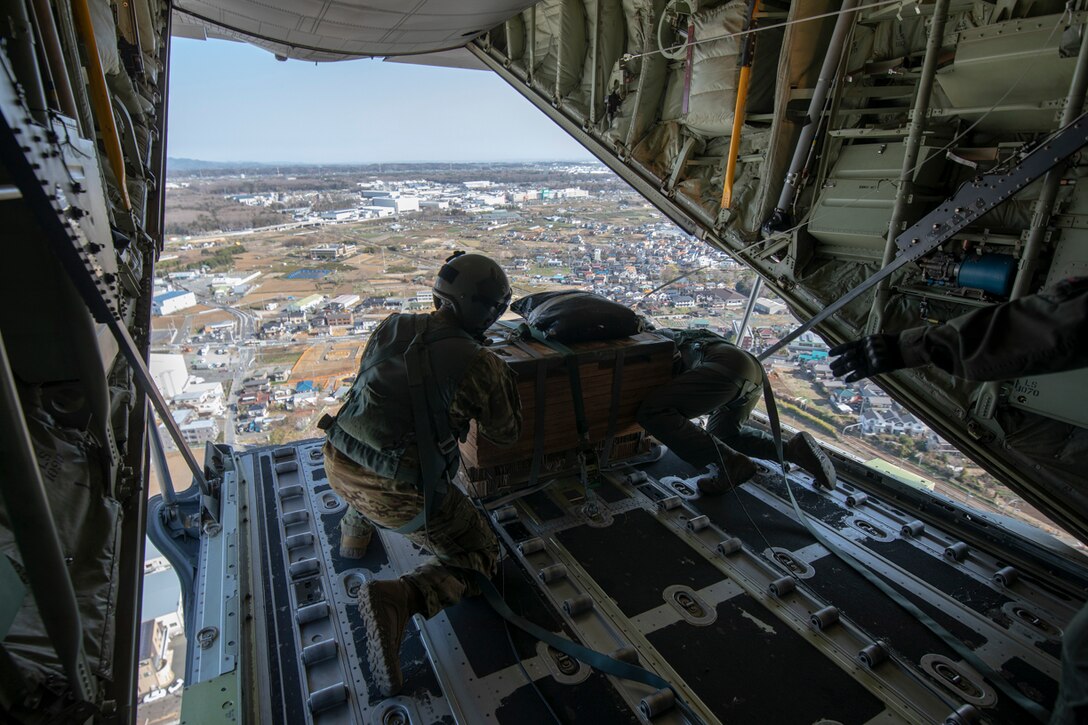 (Left to right) Tech. Sgt. Brian Gates and Airman 1st Class Matthew Pfeffer, 36th Airlift Squadron C-130J loadmasters