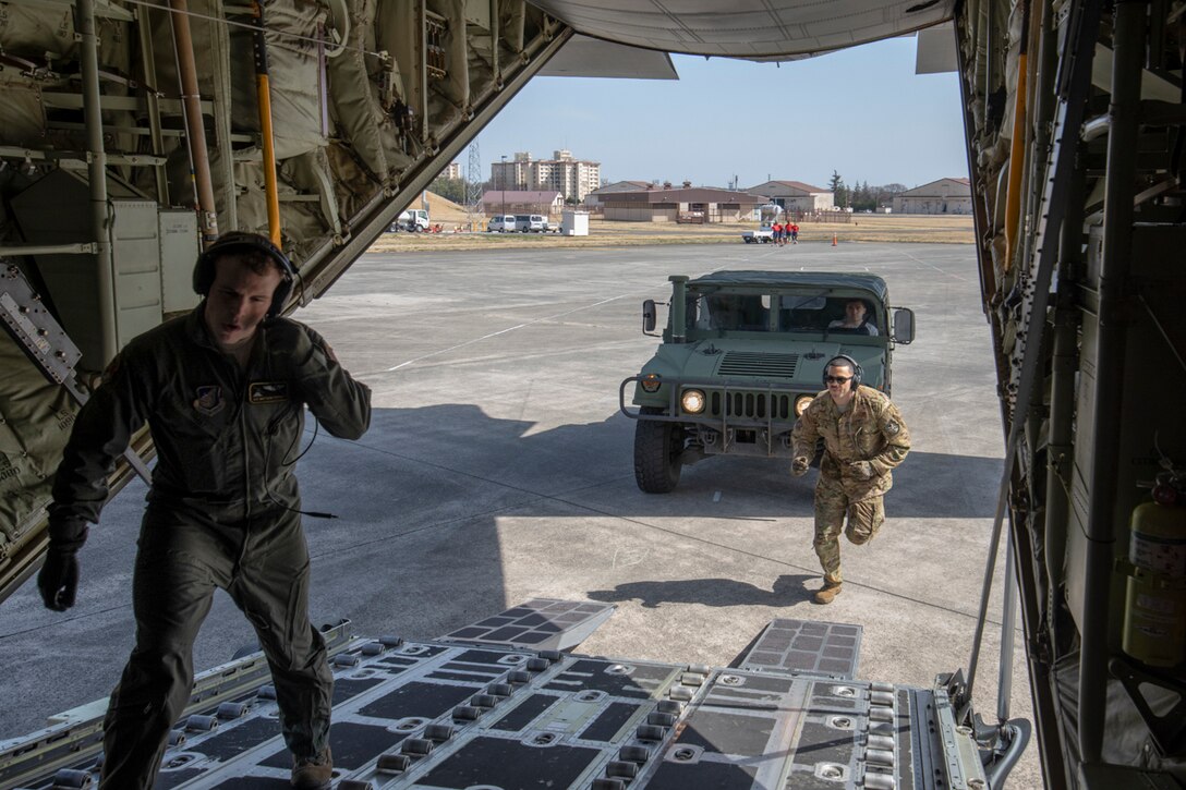 (Left to right) Airman 1st Class Matthew Pfeffer and Tech. Sgt. Brian Gates, both with the 36th Airlift Squadron C-130J loadmasters