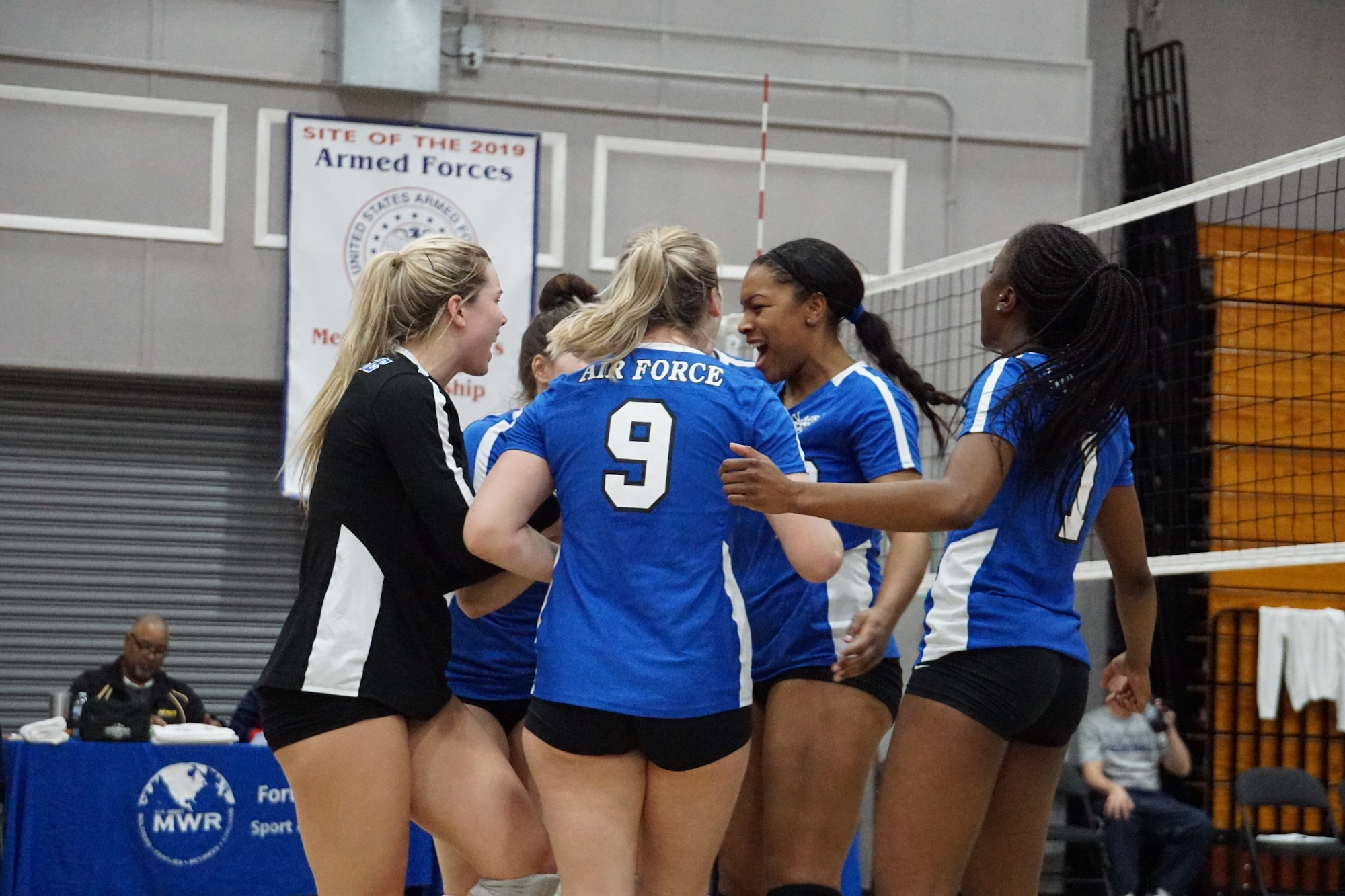 Senior Airman Jade Cairns (second from right), 60th Diagnostics and Therapeutics Squadron medical laboratory technician, celebrates with her teammates during the 2019 Armed Forces Volleyball Championship at Fort Bragg, North Carolina, Mar. 8, 2019. Army, Navy (with Coast Guard) and Air Force teams squared off at the annual AFVC through three days of round-robin competition, to eventually crown the best men and women volleyball players in the military. (U.S. Navy photo by Mass Communications Specialist 1st Class John Benson)