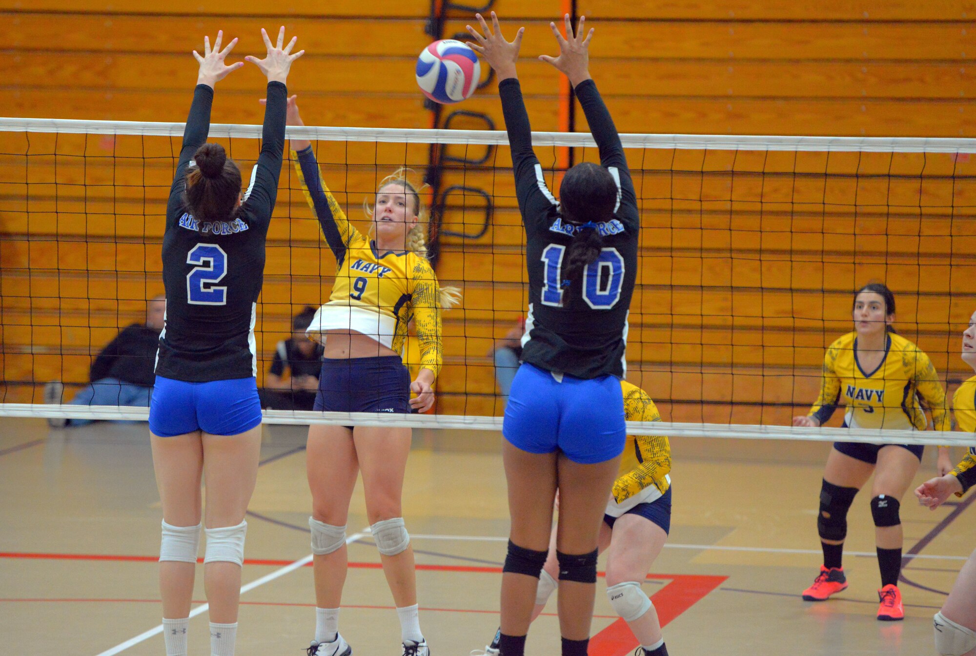 Senior Airman Jade Cairns (number 10), 60th Diagnostics and Therapeutics Squadron medical laboratory technician, jumps up for a block during the 2019 Armed Forces Volleyball Championship at Fort Bragg, North Carolina, Mar. 8, 2019. Army, Navy (with Coast Guard) and Air Force teams squared off at the annual AFVC through three days of round-robin competition, to eventually crown the best men and women volleyball players in the military. (U.S. Navy photo by Mass Communications Specialist 1st Class John Benson)