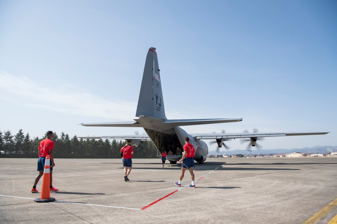 Ground crew with the 36th Airlift Squadron prepare for a combat offload of a training pallet from a C-130J Super Hercules during the Yokota C-130J Rodeo March 22, 2019, at Yokota Air Base, Japan. The goal of the competition was to have participants demonstrate their capabilities, improve procedures and enhance the standardization for tactical operations. (U.S. Air Force photo by Senior Airman Donald Hudson)