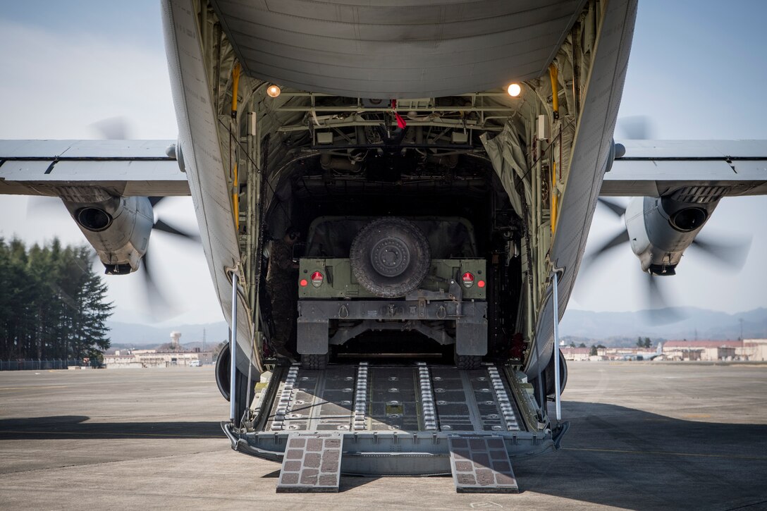 A 36th Airlift Squadron loadmaster secures a Humvee in a C-130J Super Hercules during the Yokota C-130J Rodeo March 22, 2019, at Yokota Air Base, Japan. The competition consisted of six events in execution and precision of various aircraft loading, offloading, and flying operations. (U.S. Air Force photo by Senior Airman Donald Hudson)