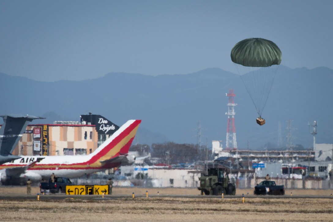 Ground crews prepare to recover an airdropped bundle during the Yokota C-130J Rodeo March 22, 2019, at Yokota Air Base, Japan. The rodeo is a friendly competition between flights within the 36th Airlift Squadron and the 374th Operations Support Squadron that promotes tactical readiness and execution of various airlift capabilities. (U.S. Air Force photo by Senior Airman Donald Hudson)