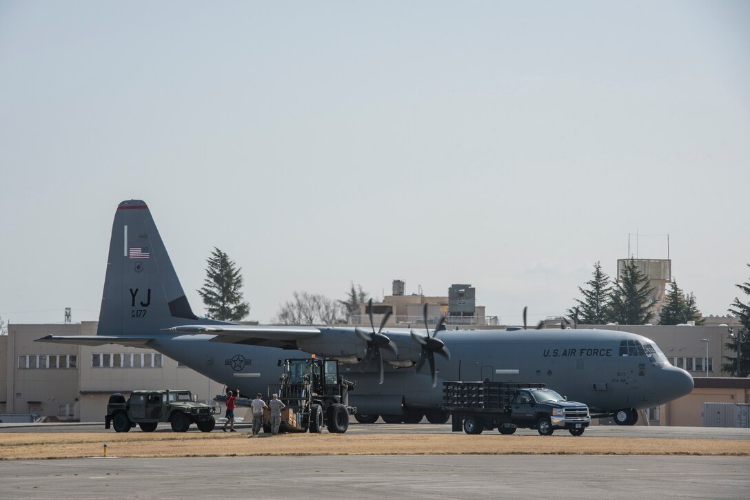 A 374th Operations Group drop zone ground crew prepare to receive a low-cost low-altitude airdrop bundle during the Yokota C-130J Rodeo March 22, 2019, at Yokota Air Base, Japan. The rodeo is a friendly competition between flights within the 36th Airlift Squadron and the 374th Operations Support Squadron that promotes tactical readiness and execution of various airlift capabilities. (U.S. Air Force photo by Senior Airman Donald Hudson)