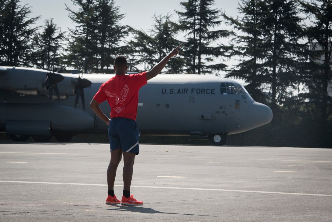 Ground crew with the 36th Airlift Squadron directs the aircrew of a C-130J Super Hercules during the Yokota C-130J Rodeo March 22, 2019, at Yokota Air Base, Japan. The competition demonstrated various combat capabilities and standards of the C-130 aircrews. (U.S. Air Force photo by Senior Airman Donald Hudson)