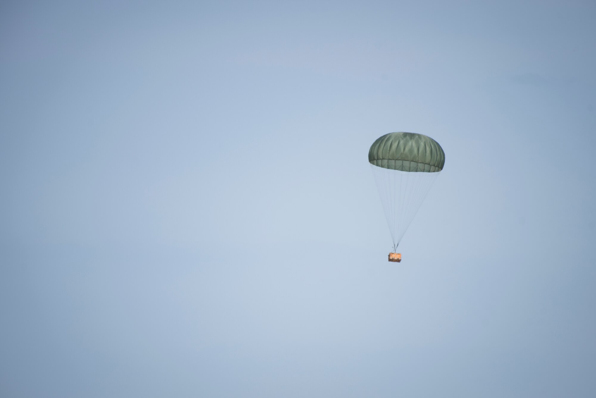 A low-cost low-altitude airdrop bundle dropped from a 36th Airlift Squadron C-130J Super Hercules floats to the designated drop zone during the Yokota C-130J Rodeo March 22, 2019, at Yokota Air Base, Japan. The goal of the competition was to have participants demonstrate their capabilities, improve procedures and enhance standardization for tactical operations. (U.S. Air Force photo by Senior Airman Donald Hudson)