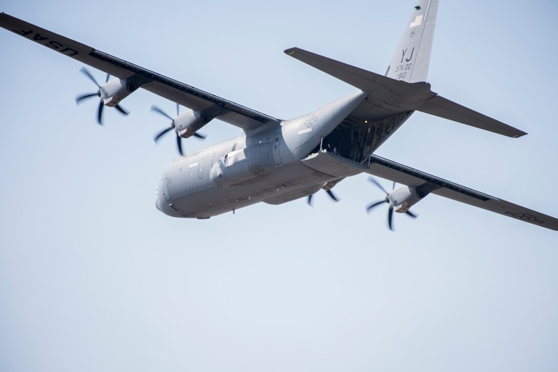 A 36th Airlift Squadron loadmaster waves to ground crews from the back of a C-130J Super Hercules during the Yokota C-130J Rodeo March 22, 2019, at Yokota Air Base, Japan. The competition consisted of six events in execution and precision of various aircraft loading, offloading, and flying operations. (U.S. Air Force photo by Senior Airman Donald Hudson)