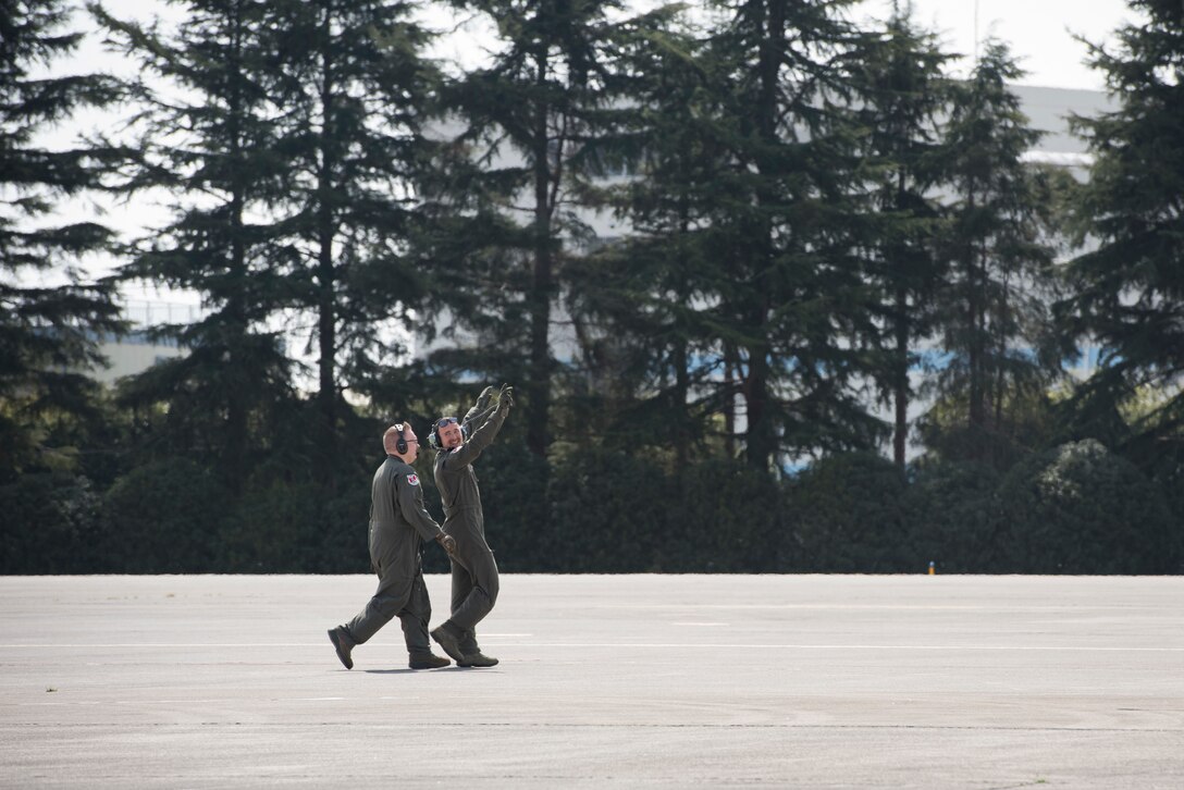 Two C-130J Super Hercules loadmasters with the 36th Airlift Squadron walk across the flightline during the Yokota C-130J Rodeo March 22, 2019, at Yokota Air Base, Japan. The goal of the competition was to have participants demonstrate their capabilities, improve procedures and enhance standardization for tactical operations. (U.S. Air Force photo by Senior Airman Donald Hudson)