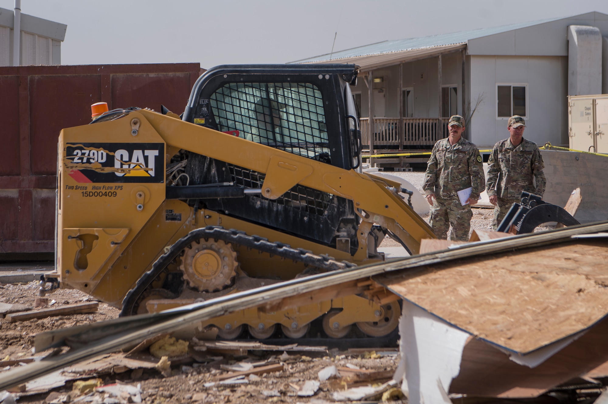 Master Sgt. Christopher Beckett, left, 379th Expeditionary Civil Engineer Squadron (ECES) heavy equipment section chief, and Tech. Sgt. John Beckett, right, 379th ECES heavy equipment project lead, check the progress of a construction site March 27, 2019, at Al Udeid Air Base, Qatar. The brothers, who have served in the Arizona Air National Guard since 2003, are currently deployed together to the same ECES unit at Al Udeid Air Base. (U.S. Air Force photo by Tech. Sgt. Christopher Hubenthal)