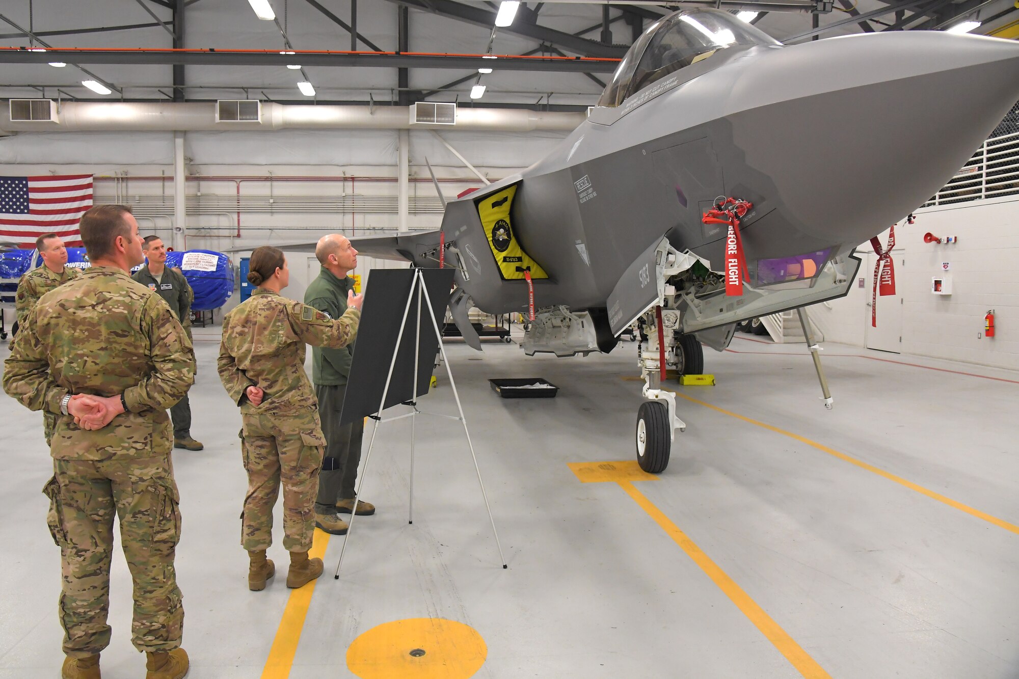Gen. Mike Holmes, commander of Air Combat Command, is briefed about the status of the wing by Capt. Dayna Grant, 388th Aircraft Maintenance Squadron, during a visit to the 388th Fighter Wing March 26, 2019, at Hill Air Force Base, Utah. (U.S. Air Force photo by Todd Cromar)
