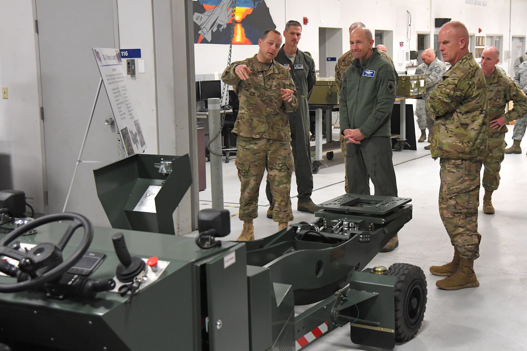 U.S. Air Force Gen. Mike Holmes, commander of Air Combat Command, center, and Command Chief Master Sgt. Frank Batten, right, are briefed about the BL-1 weapons loader by U.S. Air Force Master Sgt. Ryan Hanner, 388th Maintenance Group, during a visit to the 388th Fighter Wing March 26, 2019, at Hill Air Force Base, Utah. (U.S. Air Force photo by Todd Cromar)