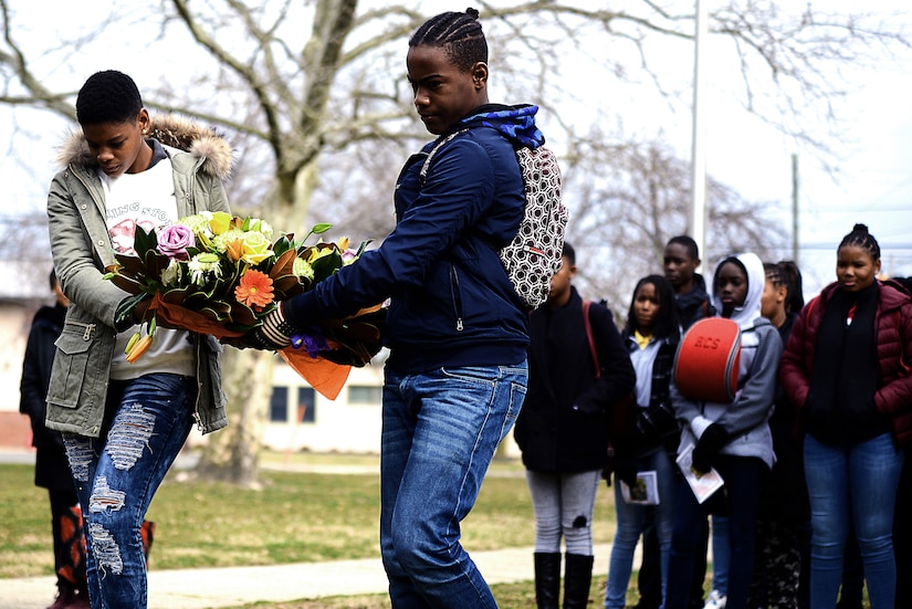 Students from the French Caribbean island of Martinique prepare to lay a wreath of remembrance during a visit to Joint Base McGuire-Dix-Lakehurst, N.J., March 25, 2019. The wreath was in honor of French dissidents who escaped the islands and fought for their freedom during World War II. The dissidents received their combat training at Fort Dix in the 1940s. (U.S. Air Force photo by Tech. Sgt. Austin Knox)