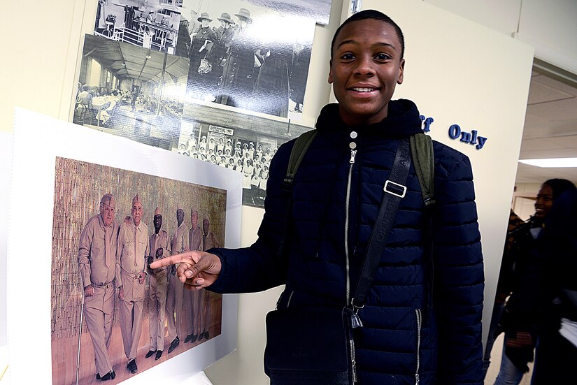 Mathyas Joseph-Duhamel, a student visiting from the French West Indies, points to a picture of his great grandfather, Henry Helenon, at the Army Reserve Mobilization Museum on Joint Base McGuire-Dix-Lakehurst, N.J., March 25, 2019. Helenon was a French dissident who escaped his island in the 1940s to train for World War II at Fort Dix. (U.S. Air Force photo by Tech. Sgt. Austin Knox)