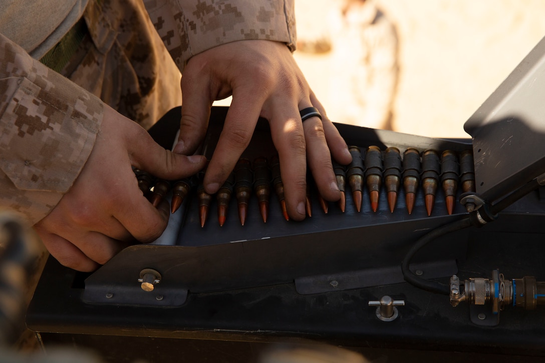 A U.S. Marine with a Low Altitude Air Defense Gunner with 2nd Low Altitude Air Defense Battalion Counter-Unmanned Aerial Systems Detachment, attached to Special Purpose Marine Air-Ground Task Force Crisis Response-Central Command, loads ammunition into the Marine Air Defense Integrated System Mine Resistant Ambush Protected Vehicle during a live-fire range in southwest Asia Feb. 18, 2019. By adapting from conventional aircraft defense systems to more non-conventional aerial threats, LAAD puts more Marines in the fight and enhances regional theatre security. SPMAGTF-CR-CC is specifically designed to be capable of deploying aviation, ground, and logistics forces forward at a moment’s notice.