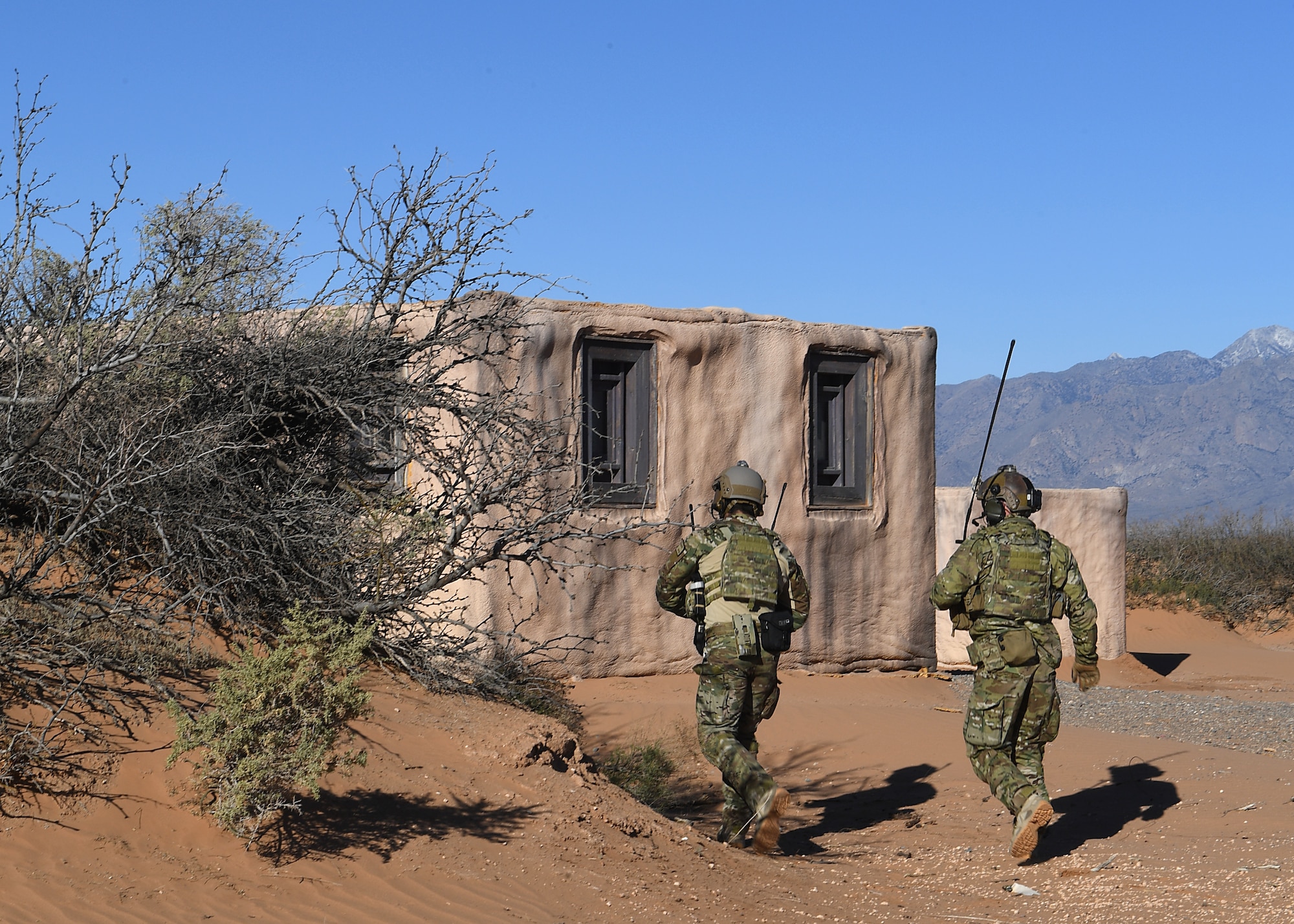 U.S. Air Force combat rescue officer students from the 351st Special Warfare Training Squadron train with tactical air control party members, assigned to the 7th Air Support Operations Squadron, on calling in close air support and nine lines on Red Rio Range, N.M., March 14, 2019. The CROs and TACPs worked with MQ-9 Reapers from Holloman Air Force Base, N.M., to simulate real world scenarios and improve communication with the pilots. (U.S. Air Force photo by  Senior Airman Haley Phillips)