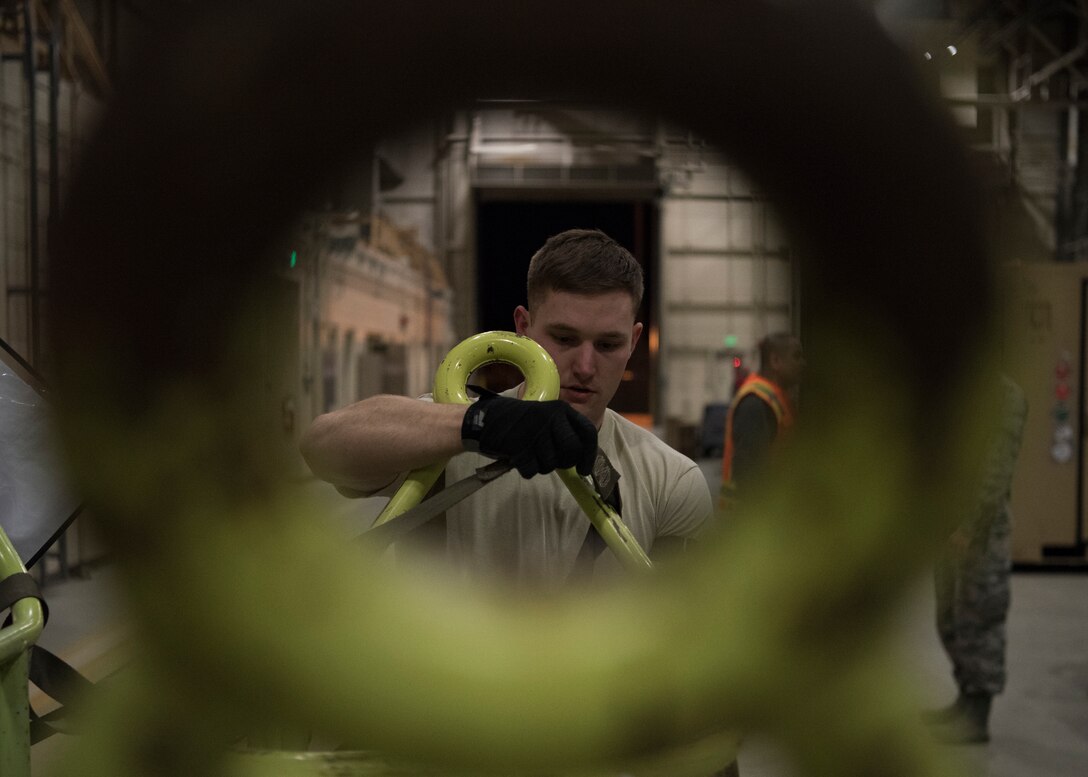 U.S. Air Force Staff Sgt. Lukus Pence, 732d Air Mobility Squadron air freight operations supervisor, tightens a cargo strap on a pallet full of aircraft fire extinguishers during Polar Force 19-4 at Joint Base Elmendorf-Richardson, Alaska, March 24, 2019. Polar Force is a two-week exercise designed to test JBER’s mission readiness. Exercises like this strengthen and develop the skills service members require when facing adverse situations.