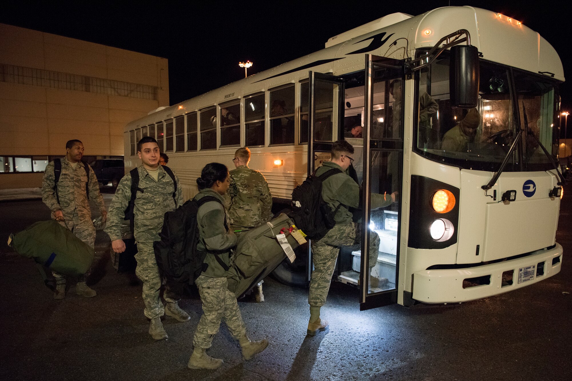 Airmen board a shuttle during a simulated deployment for Polar Force 19-4 at Joint Base Elmendorf-Richardson, Alaska, March 25, 2019. Polar Force is a two-week exercise designed to test JBER’s mission readiness. Exercises like this strengthen and develop the skills service members require when facing adverse situations.