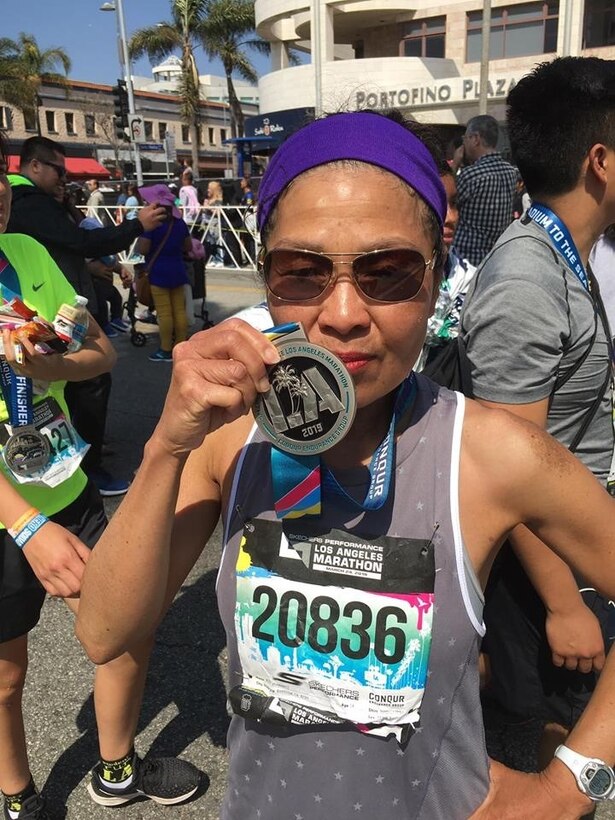 Rose Schwartz, wife of Chip Schwartz, plant manager at Production Plant Barstow, Marine Depot Maintenance Command, poses with her medal after competing in the LA Marathon, in Los Angeles, Calif., March 24. This was her first full marathon, having run in many shorter races over the years.