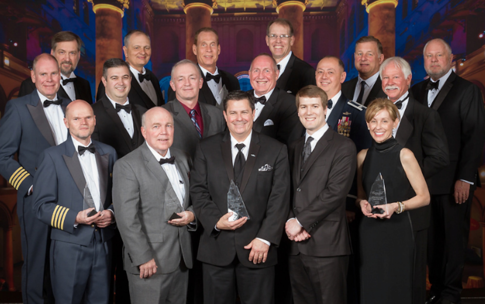 Kevin Price, Air Force Research Laboratory program manager (maroon shirt) stands to the left of Edward Griffin of Lockheed Martin, along with other winners of the 2019 Aviation Week Laureate Awards at a formal ceremony at the National Building Museum in Washington, D.C. March 14, 2019. AFRL, Lockheed Martin and Office of the Secretary of Defense won the safety award in the defense category for Auto-ICAS, a life-saving aircraft technology. (Photo by Chris Zimmer, Aviation Week)