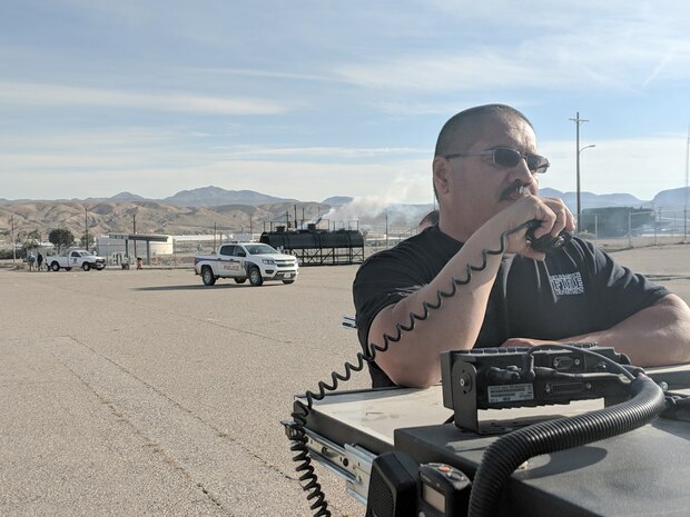 Domingo Duran, Assistant Fire Chief, MCLBB Fire and Emergency Services Division, reports simulated rail tanker car gas leak during Exercise Haber Rail aboard Marine Corps Logistics Base Barstow, Calif., March 19.