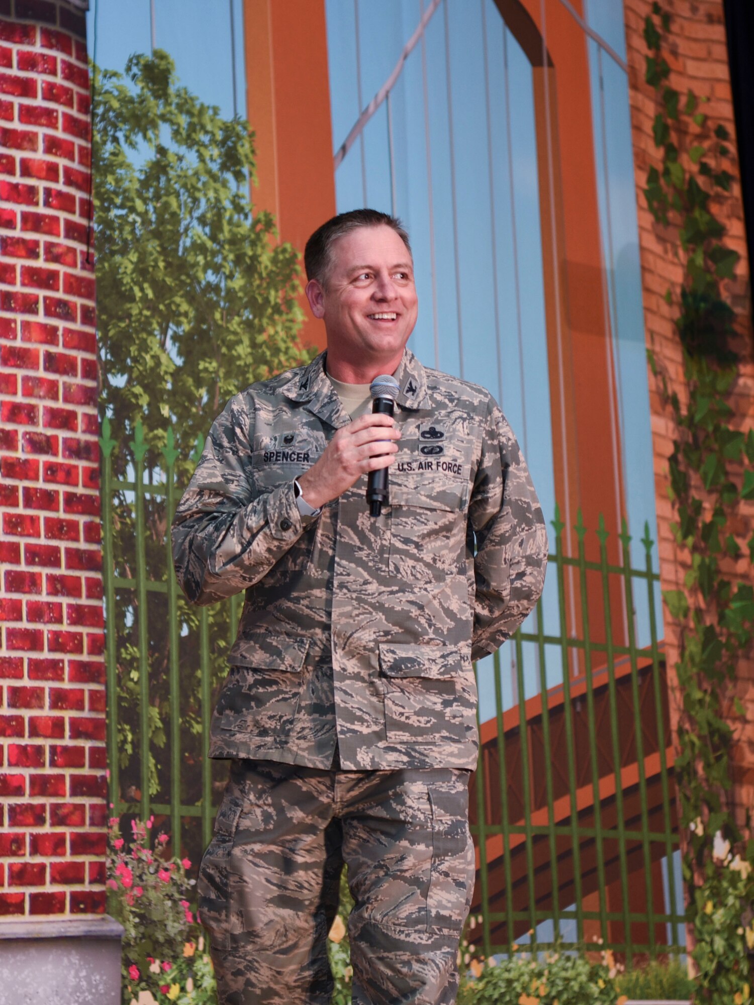 Colonel Benjamin Spencer, 319th Air Base Wing commander, interacts with the audience before a production of Sesame Street Live March 26, 2019, on Grand Forks Air Force Base, North Dakota. Spencer gave opening remarks before the performance began, and thanked the Sesame Street Live cast for coming to the base. (U.S. Air Force photo by Airman 1st Class Melody Wolff)