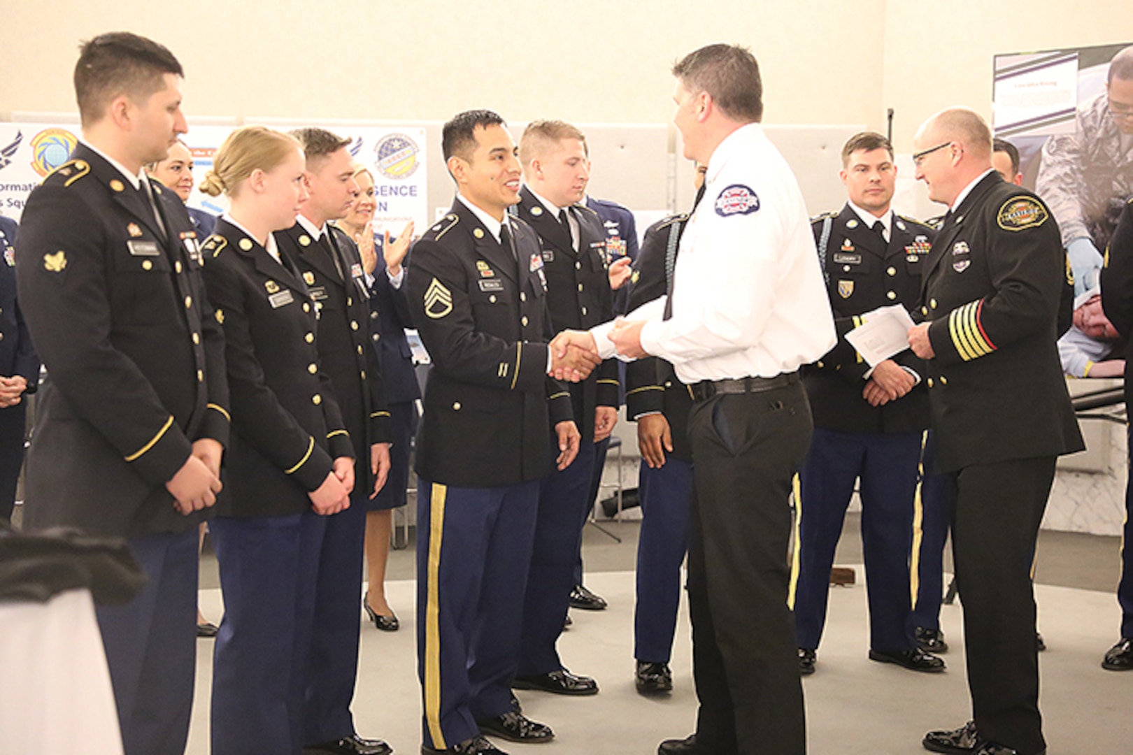 Eastside Fire Deputy Chief Rich Burke and Capt. Steven Johnson, Eastside Fire & Rescue, thank the Guard members during a ceremony on March 27, 2019, at the State Capitol in Olympia, Wash. Eastside Fire & Rescue honored the Guard for their support following record snow fall in February. The Guard provided critical support to first responders who could not get into side roads and driveways due to snow drifts and poor road conditions.