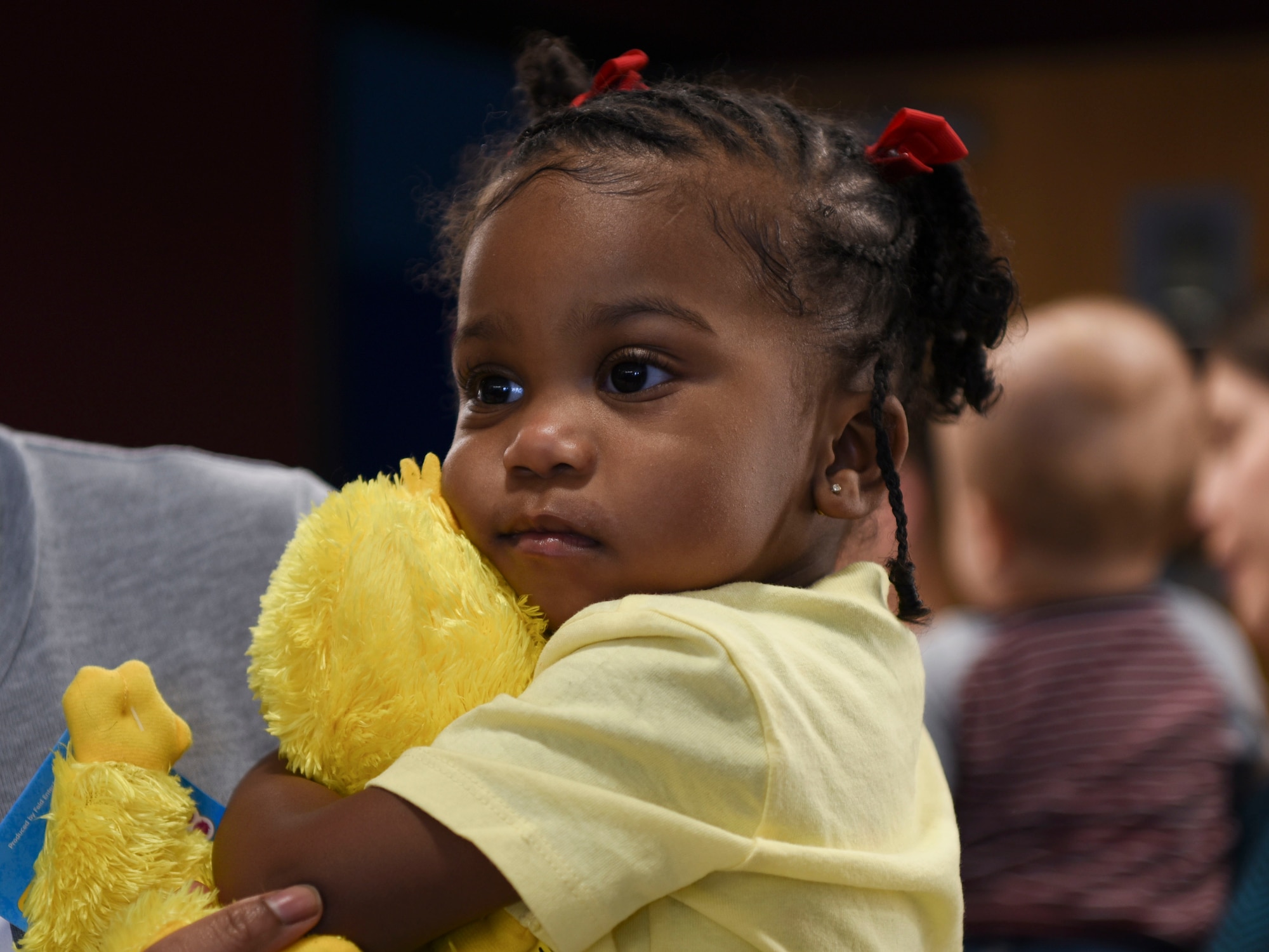 Bailey Lawson, 1, holds a Big Bird at the Sesame Street Live performance event on March 26, 2019, on Grand Forks Air Force Base, North Dakota. Lawson was one of the many children waiting in line for the Sesame Street Live performance, and chose the Big Bird plush toy as her souvenir from the show. (U.S. Air Force photo by Airman 1st Class Melody Wolff)