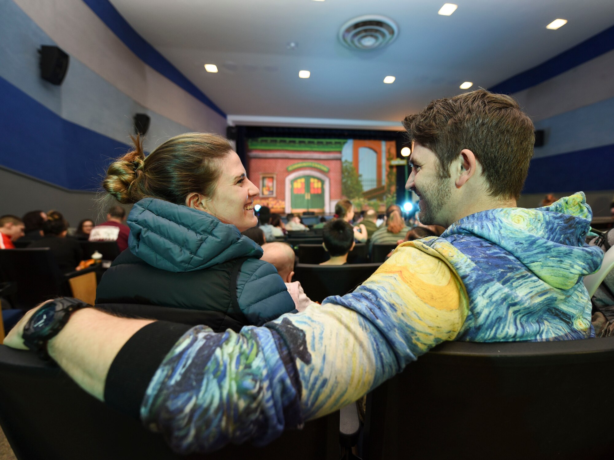 Captain Shane Coleman, 348th Reconnaissance Squadron R-Q 4 Global Hawk pilot, and his wife, Natalie Coleman, wait for the production of Sesame Street Live to begin on March 26, 2019, on Grand Forks Air Force Base, North Dakota. Natalie enjoyed the performance, and thought having Sesame Street Live come to Grand Forks AFB was a great idea for families with children. (U.S. Air Force photo by Airman 1st Class Melody Wolff)