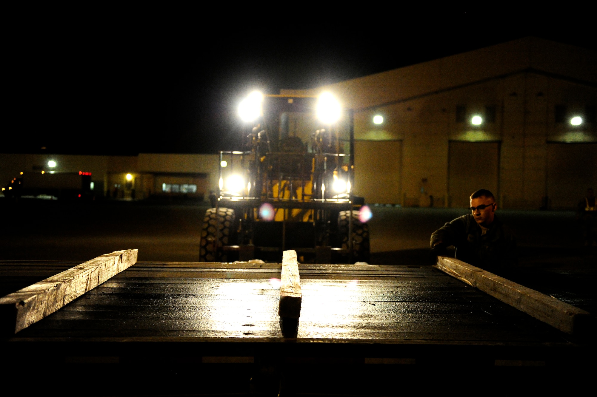 U.S. Air Force Senior Airman William Moreaux, assigned to the 773d Logistics Readiness Squadron, removes support planks from flatbed truck after unloading an equipment pallet during Polar Force 19-4 at Joint Base Elmendorf-Richardson, Alaska, March 26, 2019. Polar Force is a two-week exercise designed to test JBER’s mission readiness. Exercises like this strengthen and develop the skills service members require when facing adverse situations.