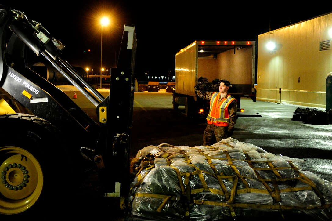 U.S. Air Force Senior Airman Dustin Downen, assigned to the 673d Logistics Readiness Squadron, accepts an equipment pallet after delivery during Polar Force 19-4 at Joint Base Elmendorf-Richardson, Alaska, March 26, 2019. Polar Force is a two-week exercise designed to test JBER’s mission readiness. Exercises like this strengthen and develop the skills service members require when facing adverse situations.