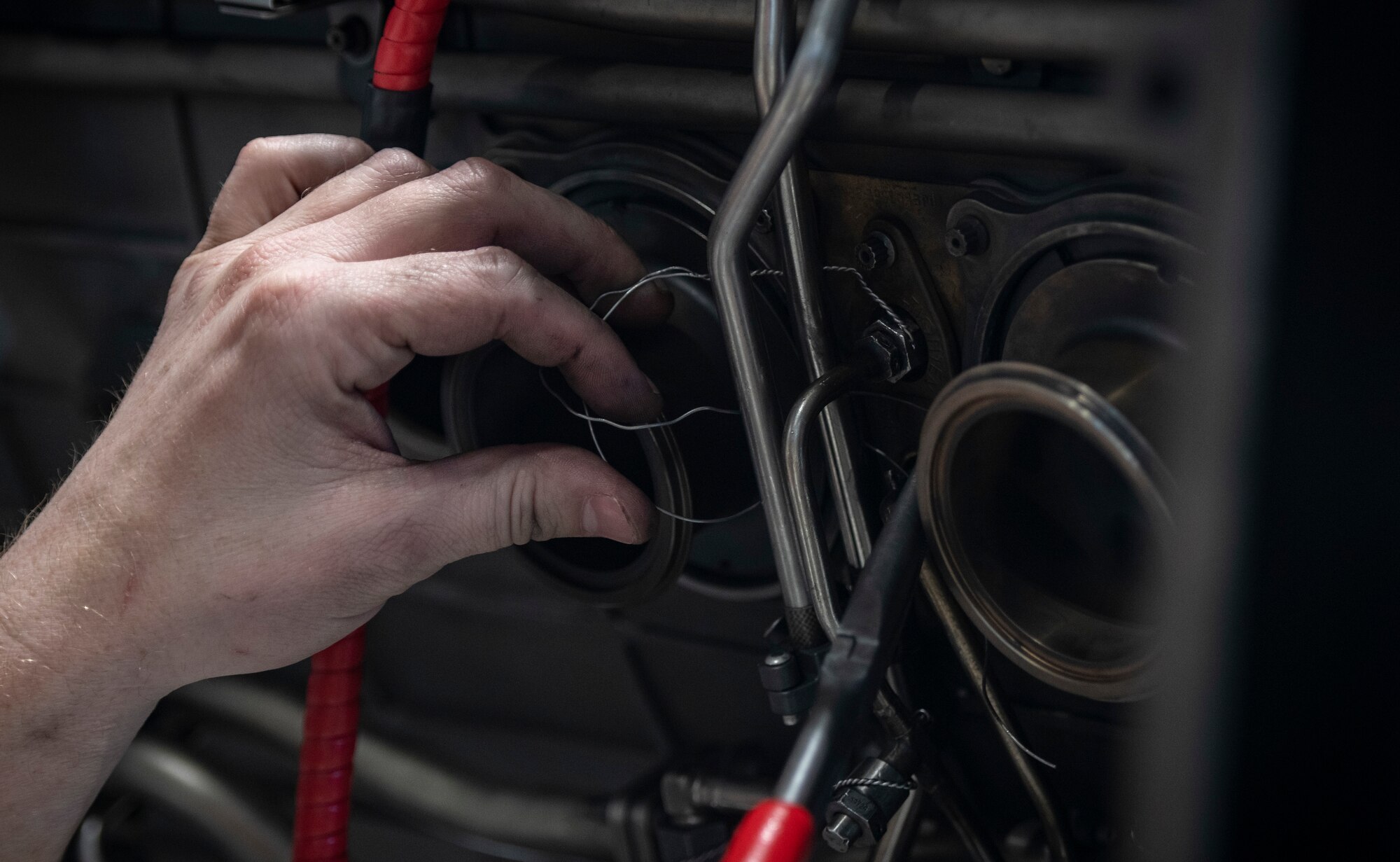 U.S. Air Force Senior Airman Nathan Evans, 20th Component Maintenance Squadron aerospace propulsion technician, applies safety wiring to an F-16 Viper engine at Shaw Air Force Base (AFB), S.C., March 27, 2019.