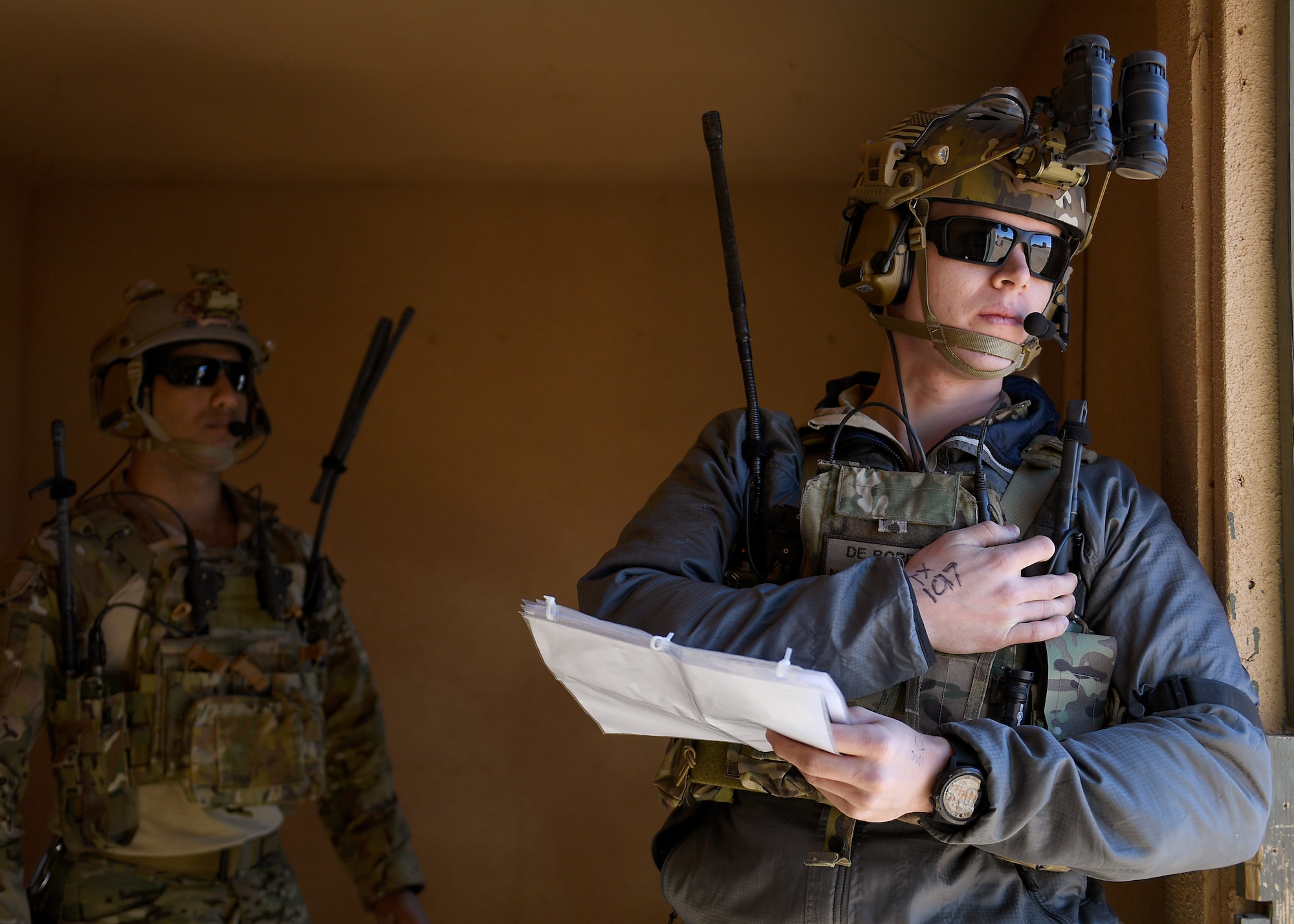 U.S. Air Force 2nd Lts. Damian (left) and William (right), 351st Special Warfare Training Squadron combat rescue officer students, train with tactical air control party members, assigned to the 7th Air Support Operations Squadron, on calling in close air support and nine lines on Red Rio Range, N.M., March 14, 2019. The CROs and TACPs worked with MQ-9 Reapers from Holloman Air Force Base, N.M., to simulate real world scenarios and improve communication with the pilots. Last names have been withheld due to operational security restraints. (U.S. Air Force photo by  Senior Airman Haley Phillips)