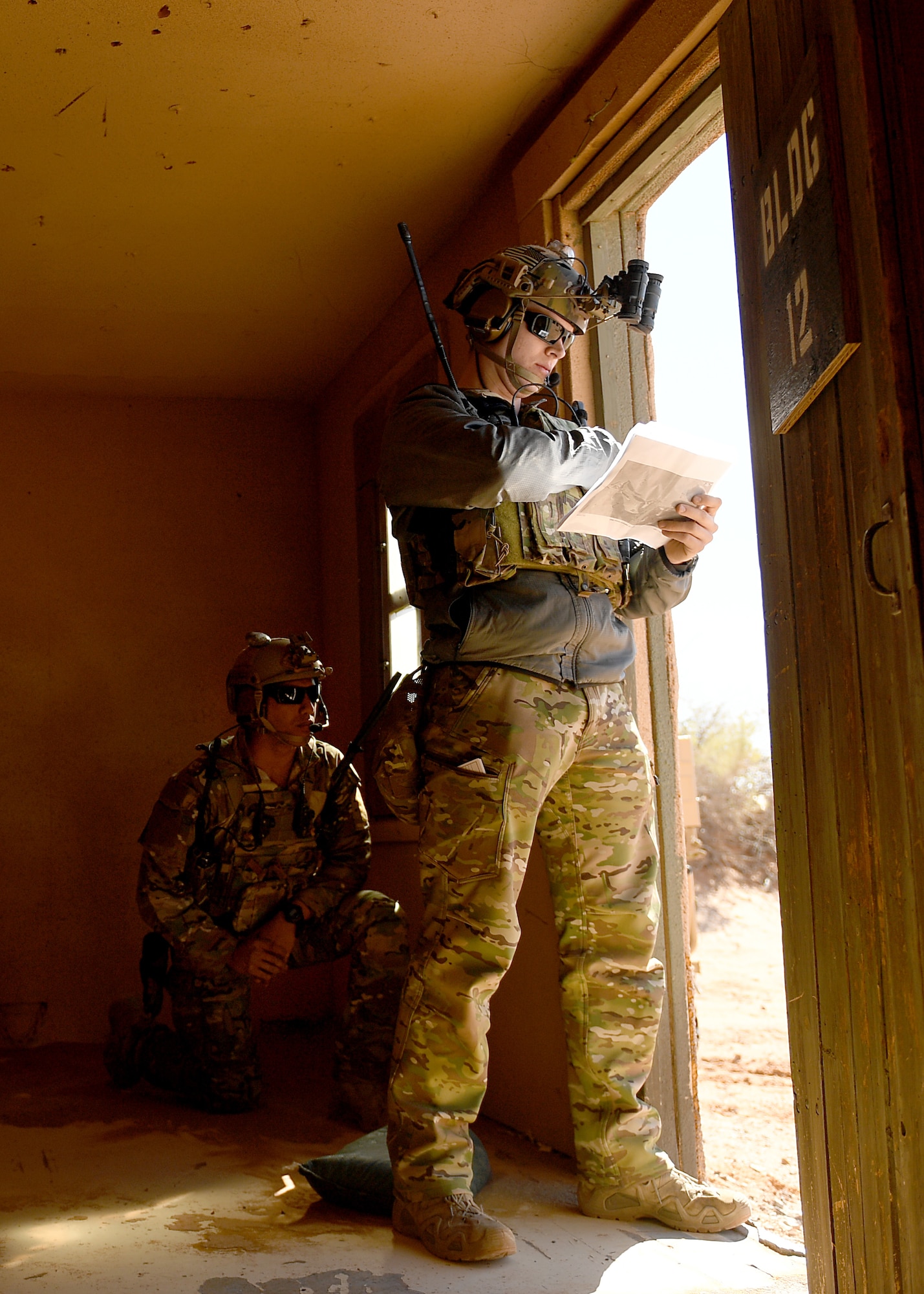 U.S. Air Force 2nd Lts. Damian (left) and William (right), 351st Special Warfare Training Squadron combat rescue officer students, train with tactical air control party members, assigned to the 7th Air Support Operations Squadron, on calling in close air support and nine lines on Red Rio Range, N.M., March 14, 2019. The CROs and TACPs worked with MQ-9 Reapers from Holloman Air Force Base, N.M., to simulate real world scenarios and improve communication with the pilots. Last names have been withheld due to operational security restraints. (U.S. Air Force photo by  Senior Airman Haley Phillips)