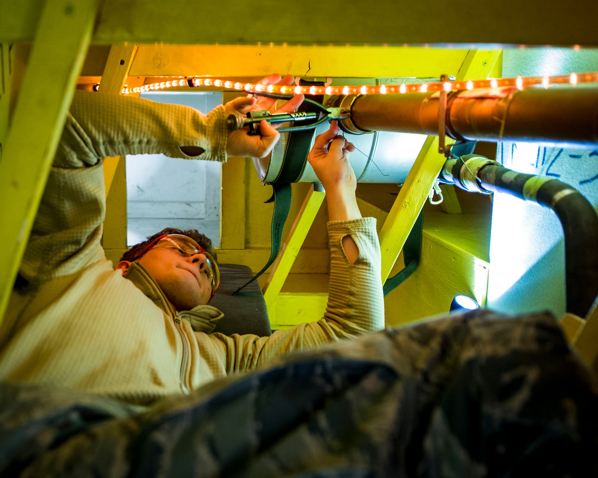 Members of the 133rd Aircraft Maintenance Squadron, Fuel Systems Maintenance shop, practice on maintenance and repairs tasks in a unique enclosed-space simulator that was created to mimic working in a real aircraft fuel tank in St. Paul, Minn., Feb. 23, 2019.