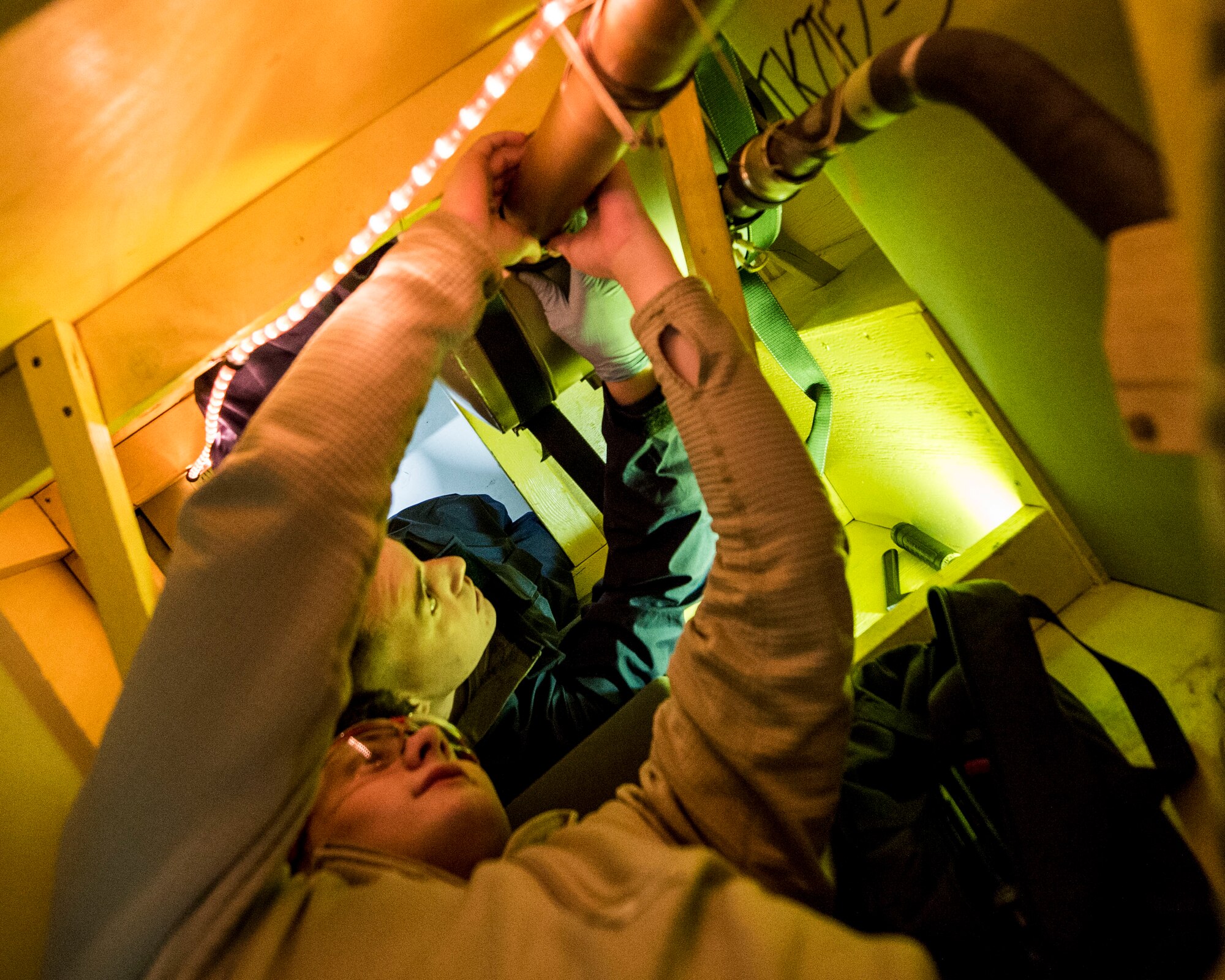 Members of the 133rd Aircraft Maintenance Squadron, Fuel Systems Maintenance shop, practice on maintenance and repairs tasks in a unique enclosed-space simulator that was created to mimic working in a real aircraft fuel tank in St. Paul, Minn., Feb. 23, 2019.