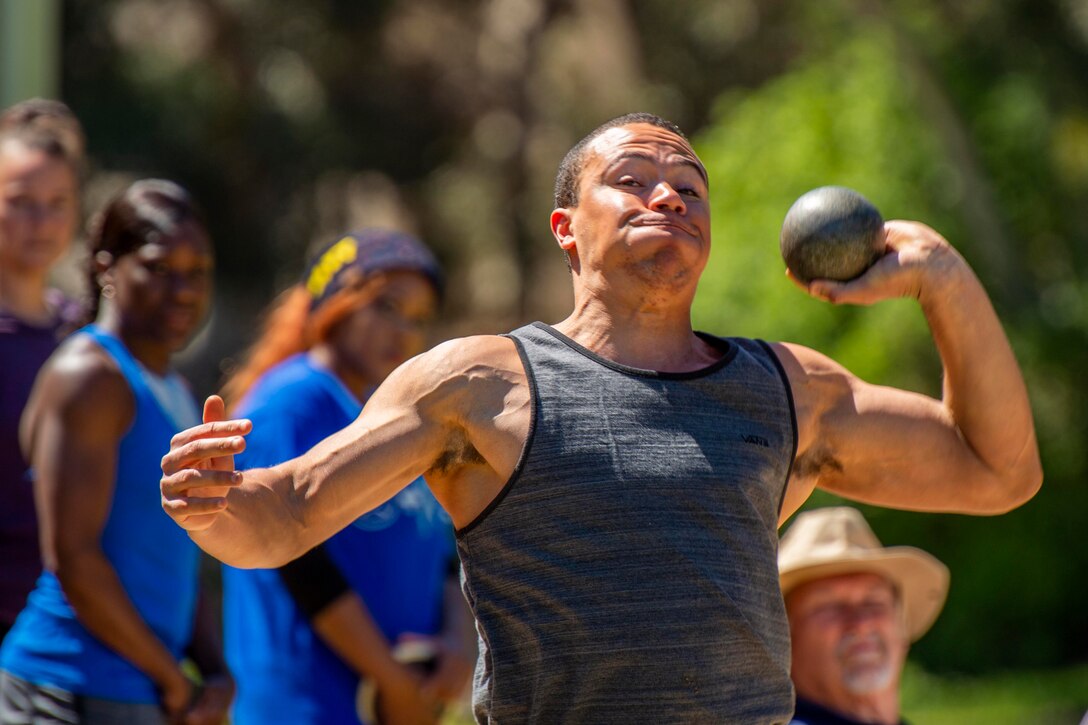 A sailor throws a shot put.