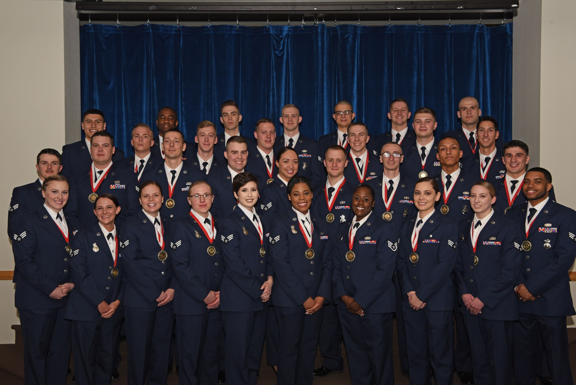 Col. Stacy Jo Huser, 90th Missile Wing commander, and Chief Master Sgt. Gemma Clark, 90th Missile Wing Interim command chief, pose with the graduating Airman Leadership School Class 19-D students in the Trail's End Event Center on F. E. Warren Air Force Base, Wyo., March 27, 2019. Enlisted Airmen must complete the rigorous professional military education course before supervising other Airmen. (U.S. Air Force photo by Senior Airman Nicole Reed)