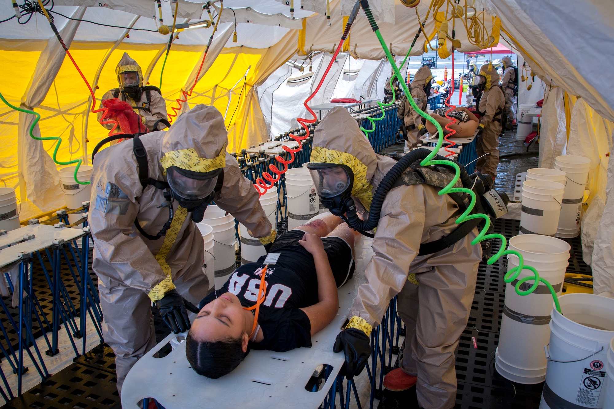 Hot-zone team members from Hawaii’s Chemical, Biological, Radiological, Nuclear, and High-Yield Explosive, Enhanced-Response-Force-Package Team (CERFP) process simulated casualties through a non-ambulatory decontamination zone during an evaluation exercise March 9, 2019, at Kalaeloa, Hawaii.